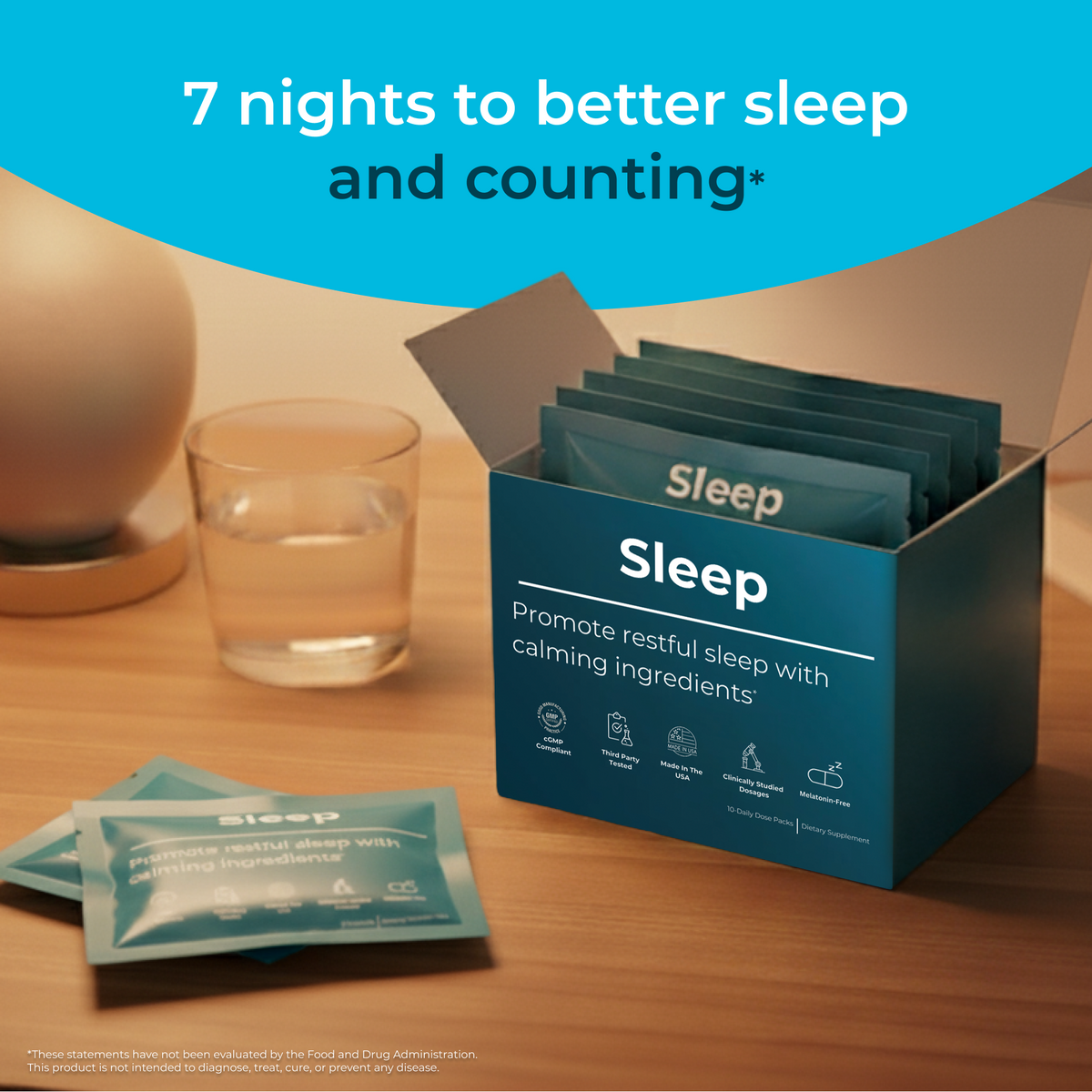 Sleep supplement packets in a box on a wooden surface with a glass of water.