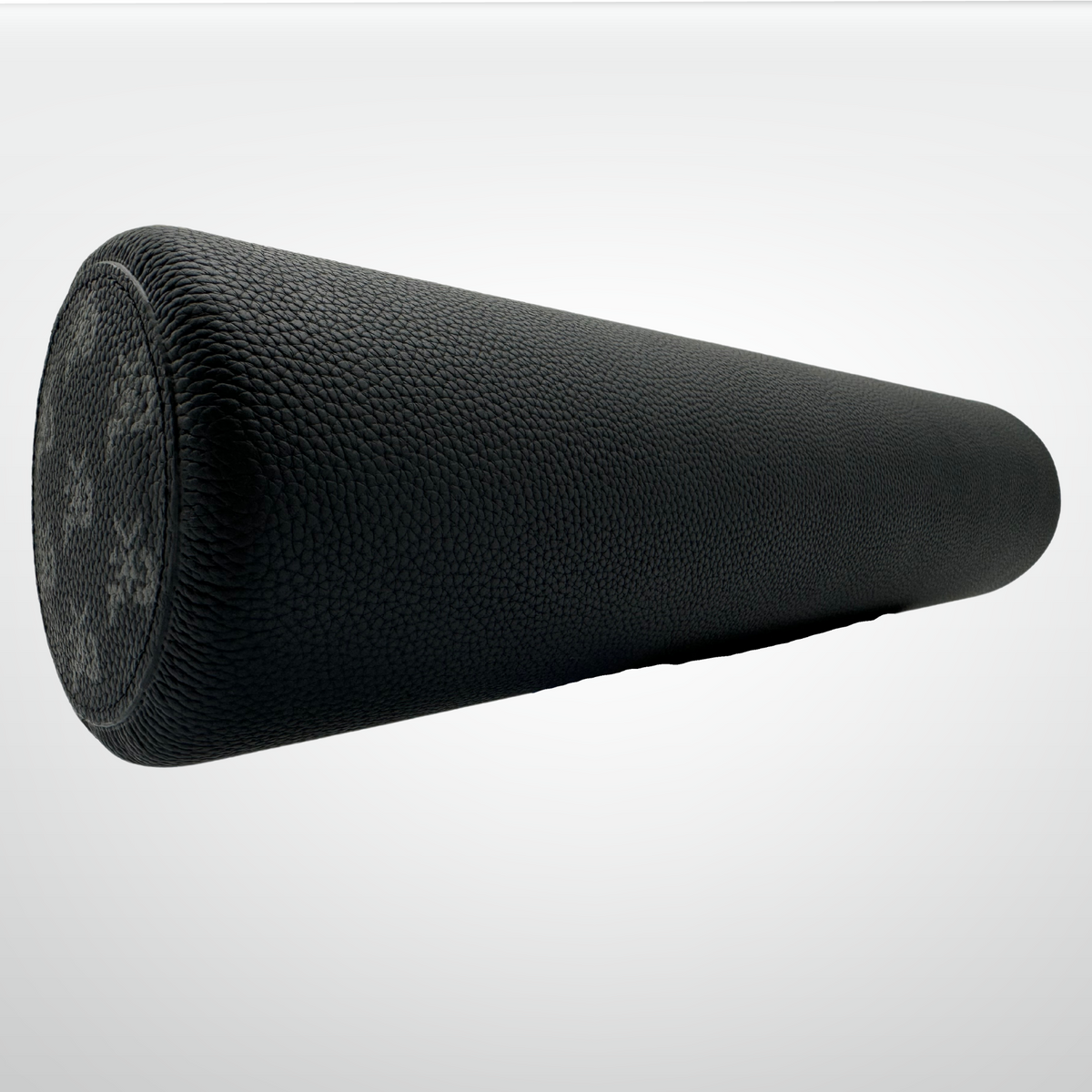 Black foam roller on a light gray background