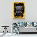 Living room with a gray sofa, decorative pillows, and a motivational quote poster on the wall.