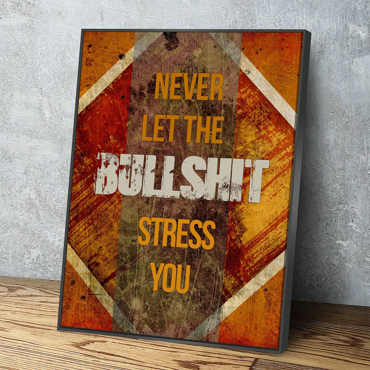 A framed motivational art print with a distressed, grunge-style design. The print features the text 'NEVER LET THE BULLSHIT STRESS YOU' in yellow and white lettering over a background of orange, brown, and beige diagonal wood-grain textures.