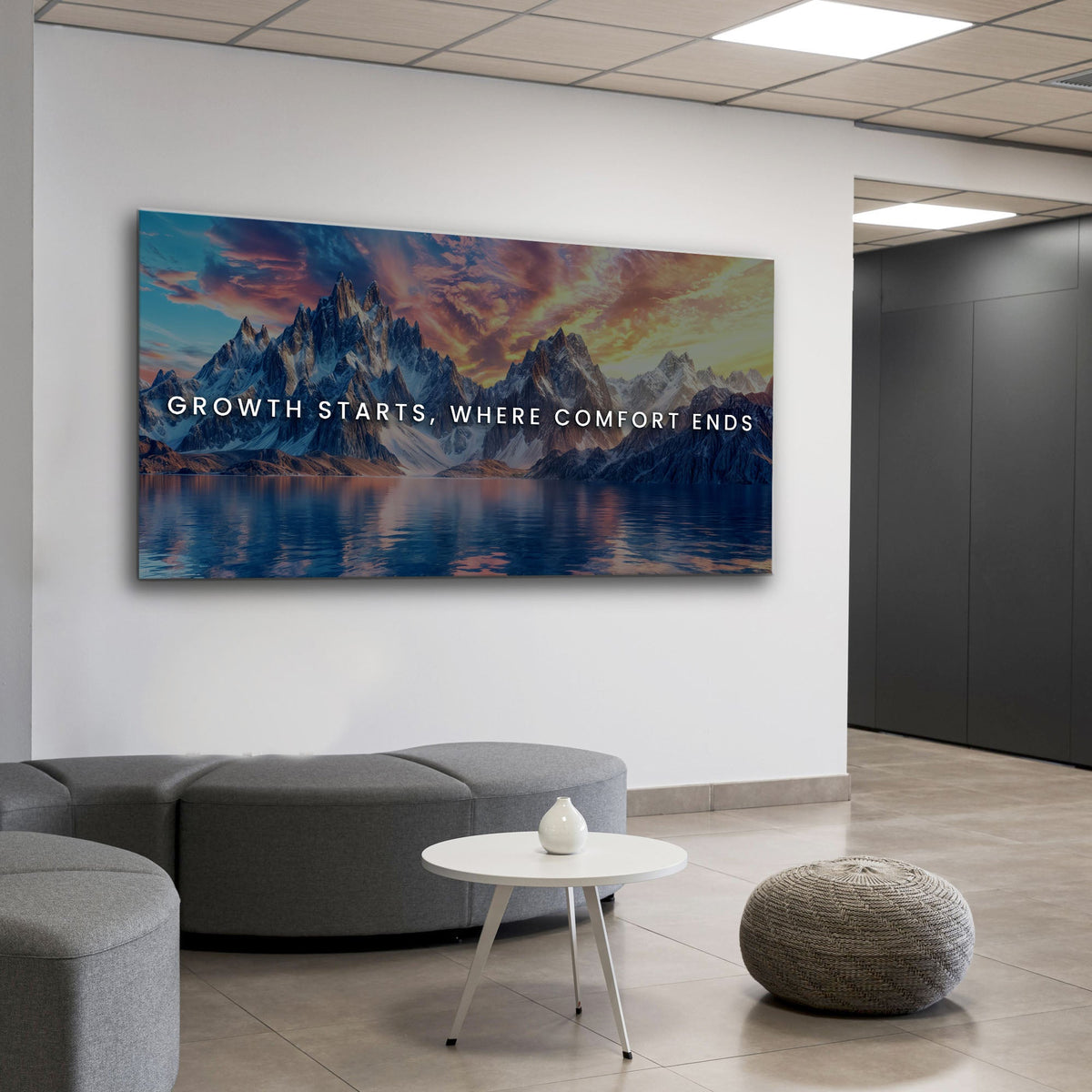 Modern office interior with a motivational quote on a mountain landscape painting.