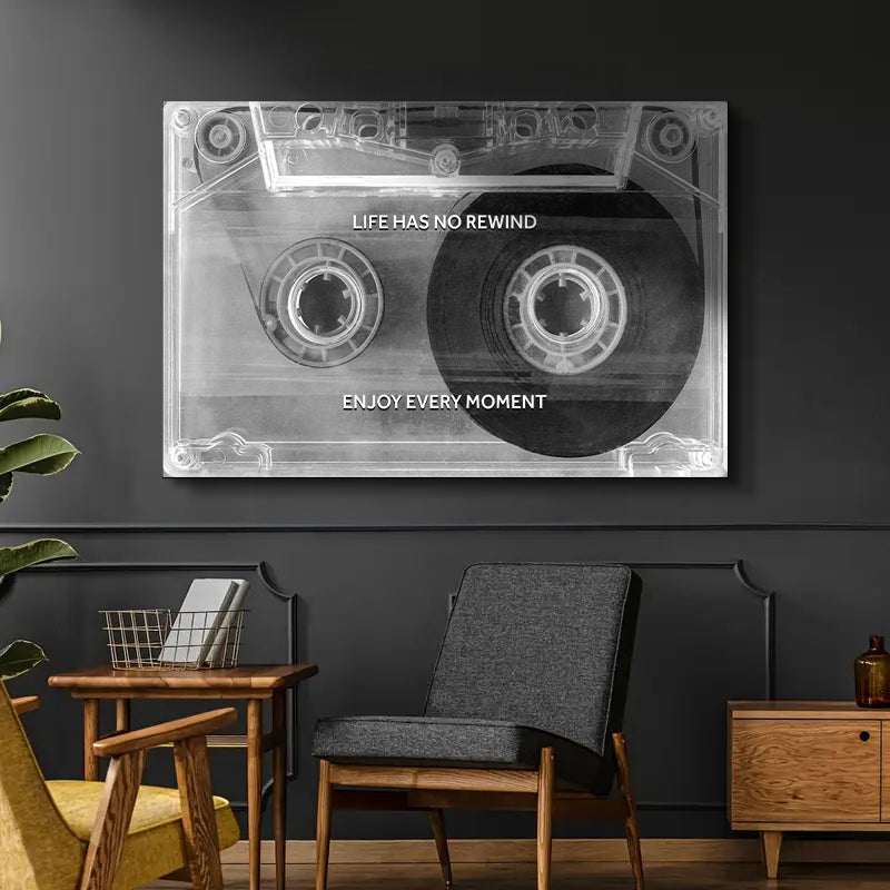 Cassette tape design wall art with motivational quote in a modern living room.