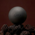 Dark gray sphere with 'LAKA' branding on a brown background