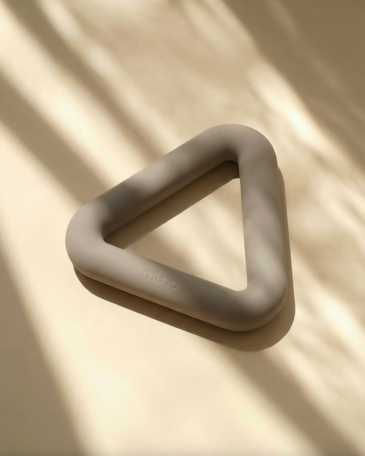 Beige silicone ring on a beige background