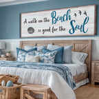 Bedroom with wooden headboard, blue and white bedding, and decorative sign.