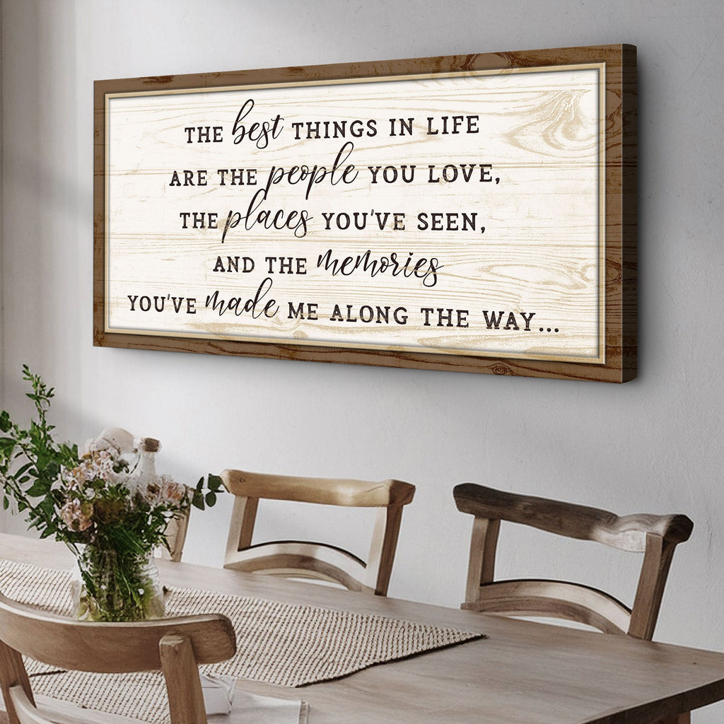 Wooden framed quote on a wall above a dining table with chairs.