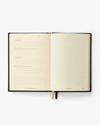 Open notebook with lined pages on a white background