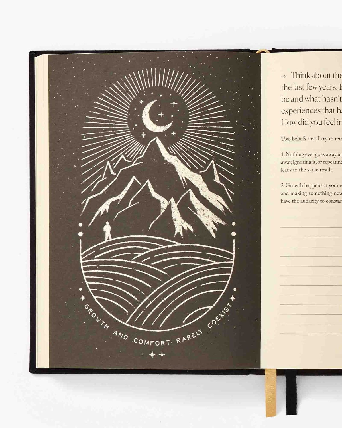 Open book with a mountain and moon illustration on a white background