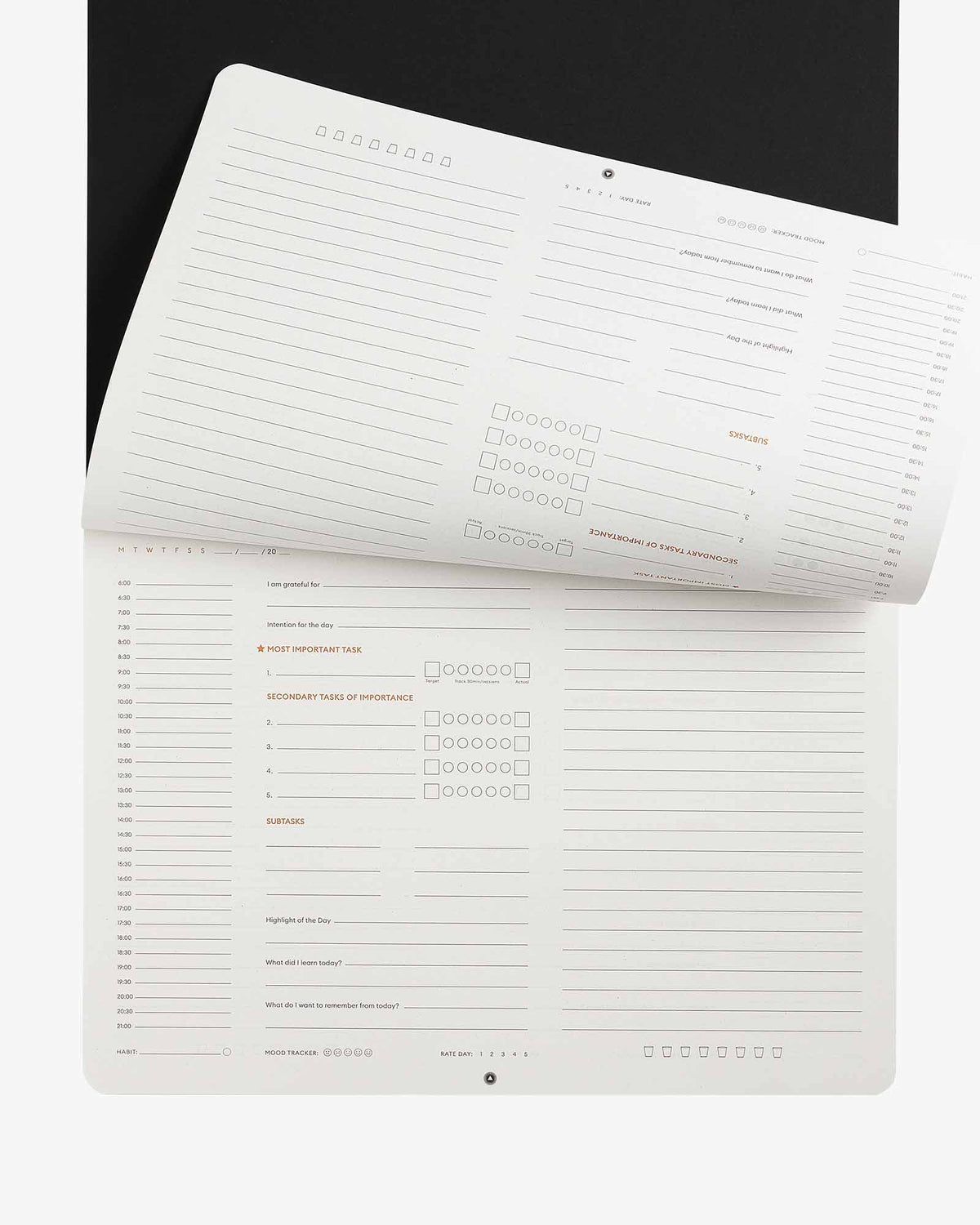 Two white planners with text on a black background
