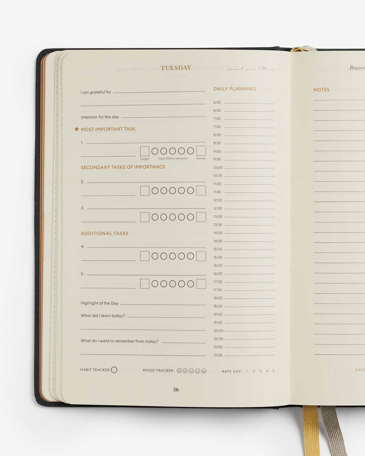 Open planner with daily schedule and notes on a white background