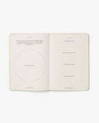 Open book with text and a circle on a white background