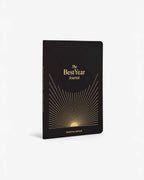 Black journal with gold text and design on a white background