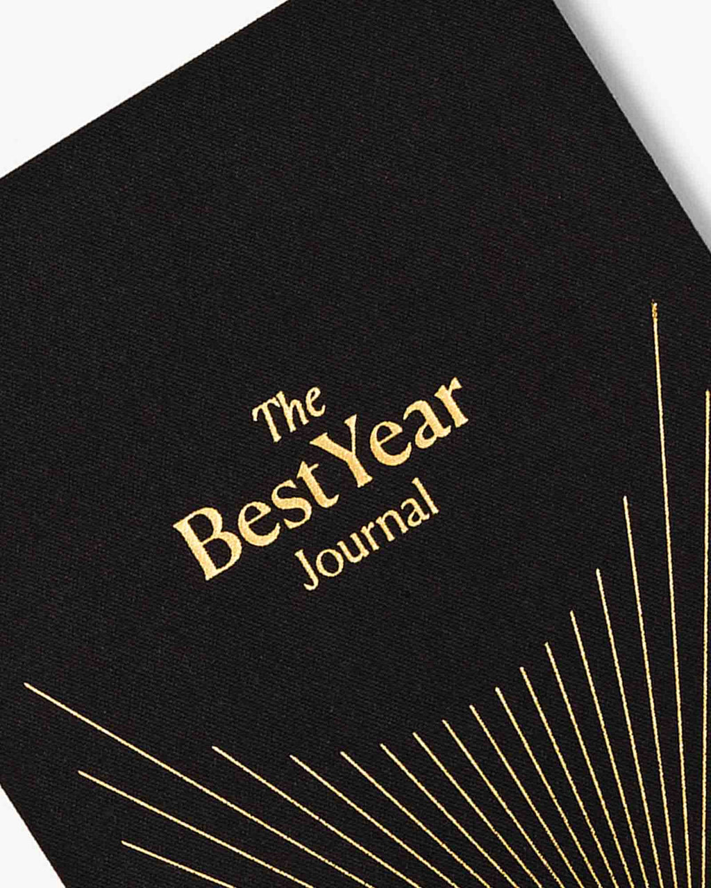 Black journal with 'The Best Year Journal' in gold text on a white background