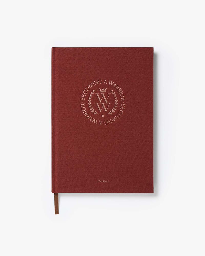 Red journal with embossed text on a white background