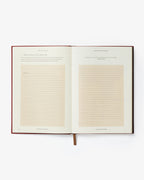 Open book with lined pages on a white background