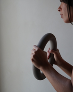 Person holding a large snake against a plain background