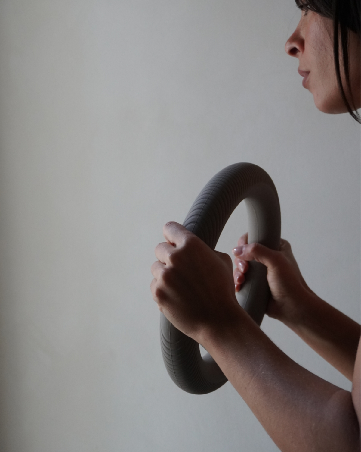 Person holding a large snake against a plain background