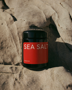 Jar of sea salt on a rocky surface