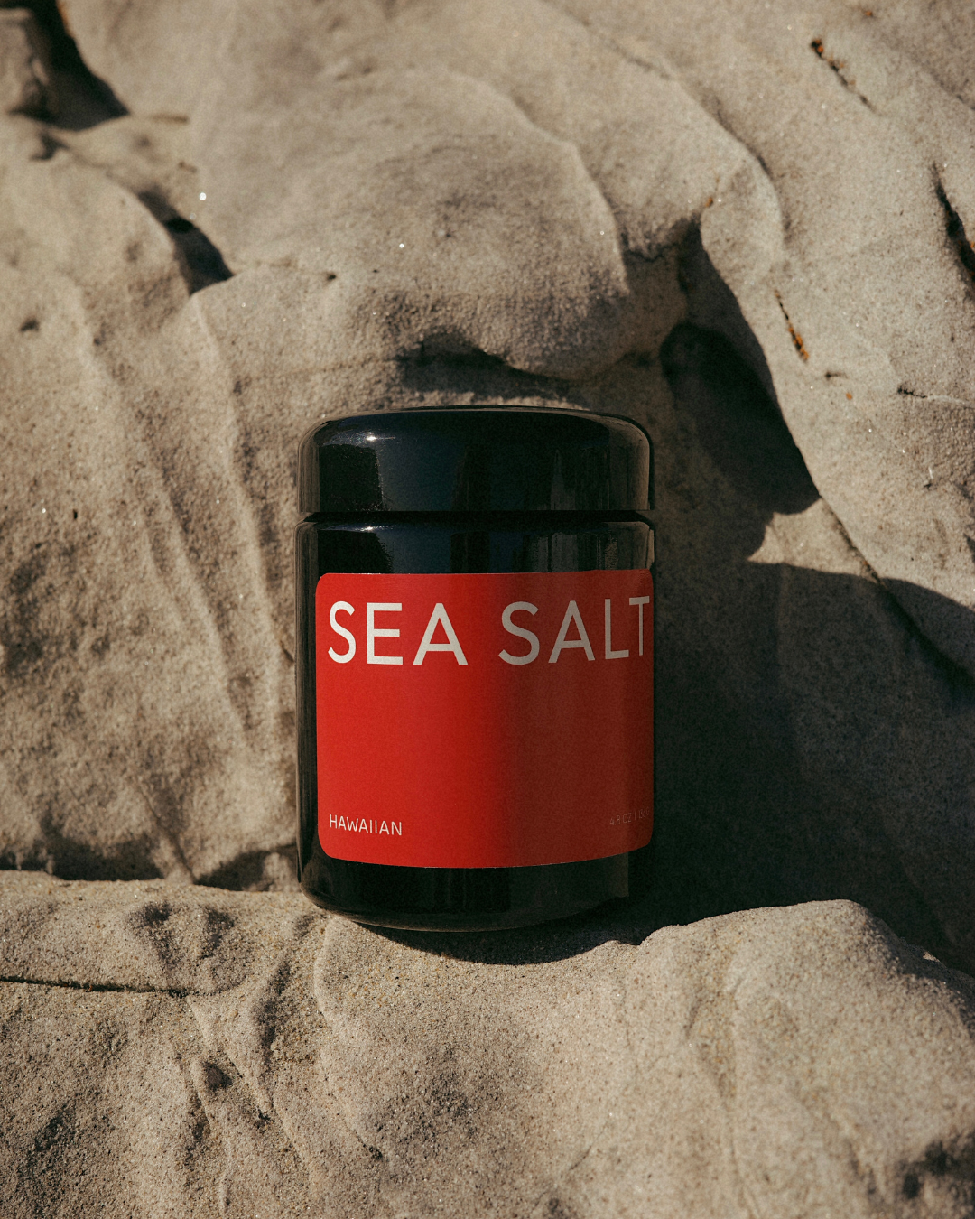 Jar of sea salt on a rocky surface