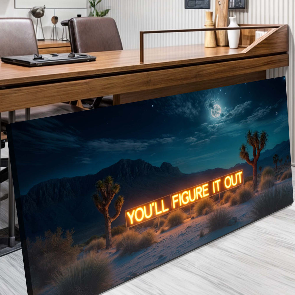 Decorative wall art with desert scene and motivational quote in an office setting