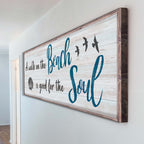 Wooden wall sign with 'Beach Soul' text on a white wall.