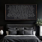 Bedroom with a framed quote on the wall, dark walls, and a bed with gray bedding.
