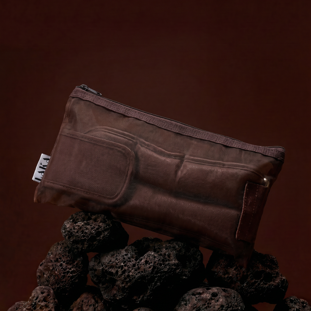 Brown pouch with a zipper on a dark brown background