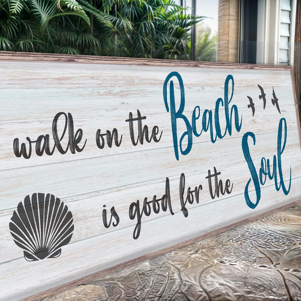 Wooden sign with 'walk on the Beach is good for the Soul' text and shell design.