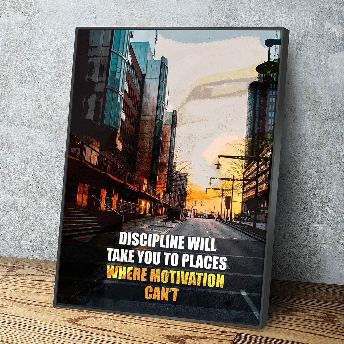 Framed poster with cityscape and motivational quote on a wooden surface and gray wall background
