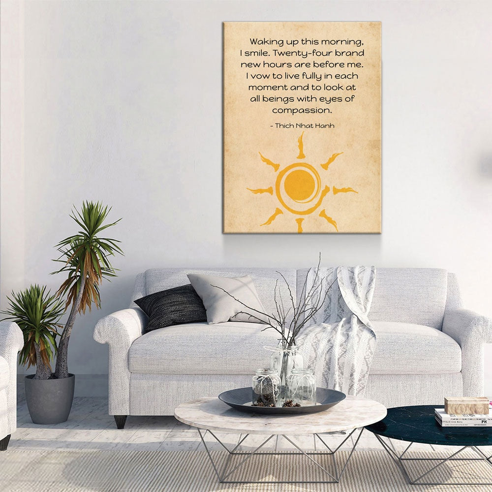 Living room with a couch, coffee table, and wall art featuring a sun design and text.