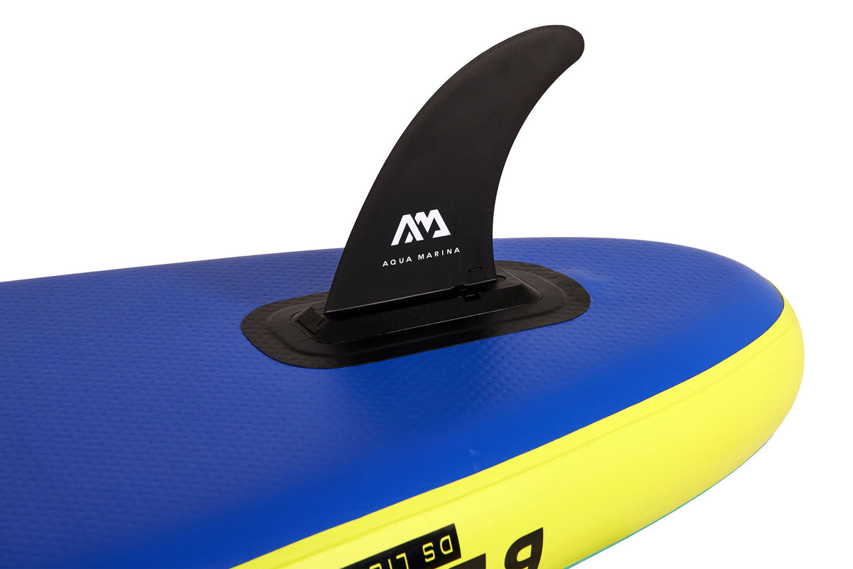 Close-up of a blue and yellow paddleboard with a black fin on a white background