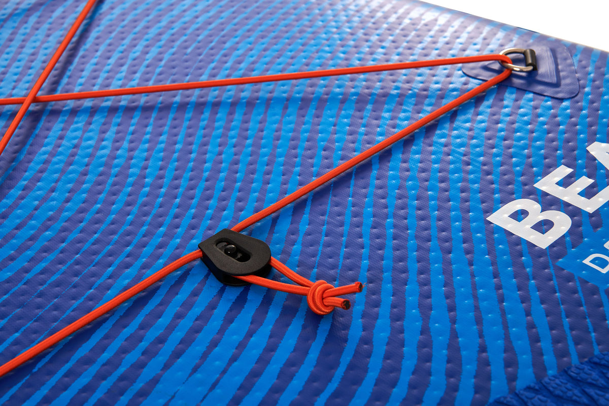 Close-up of a blue inflatable mat with orange strap and black buckle, featuring the brand 'Bear'.