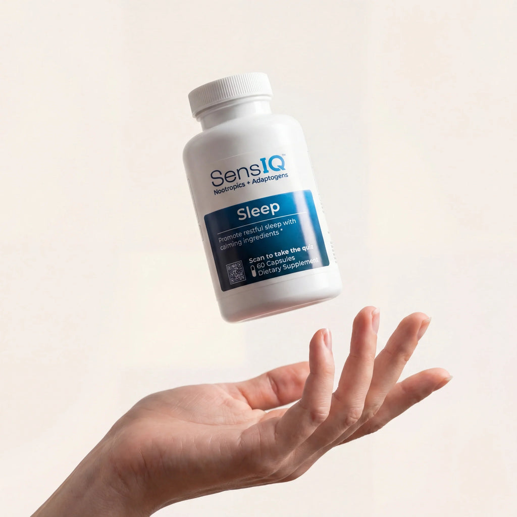 SensIQ Sleep supplement bottle held in a hand against a light background