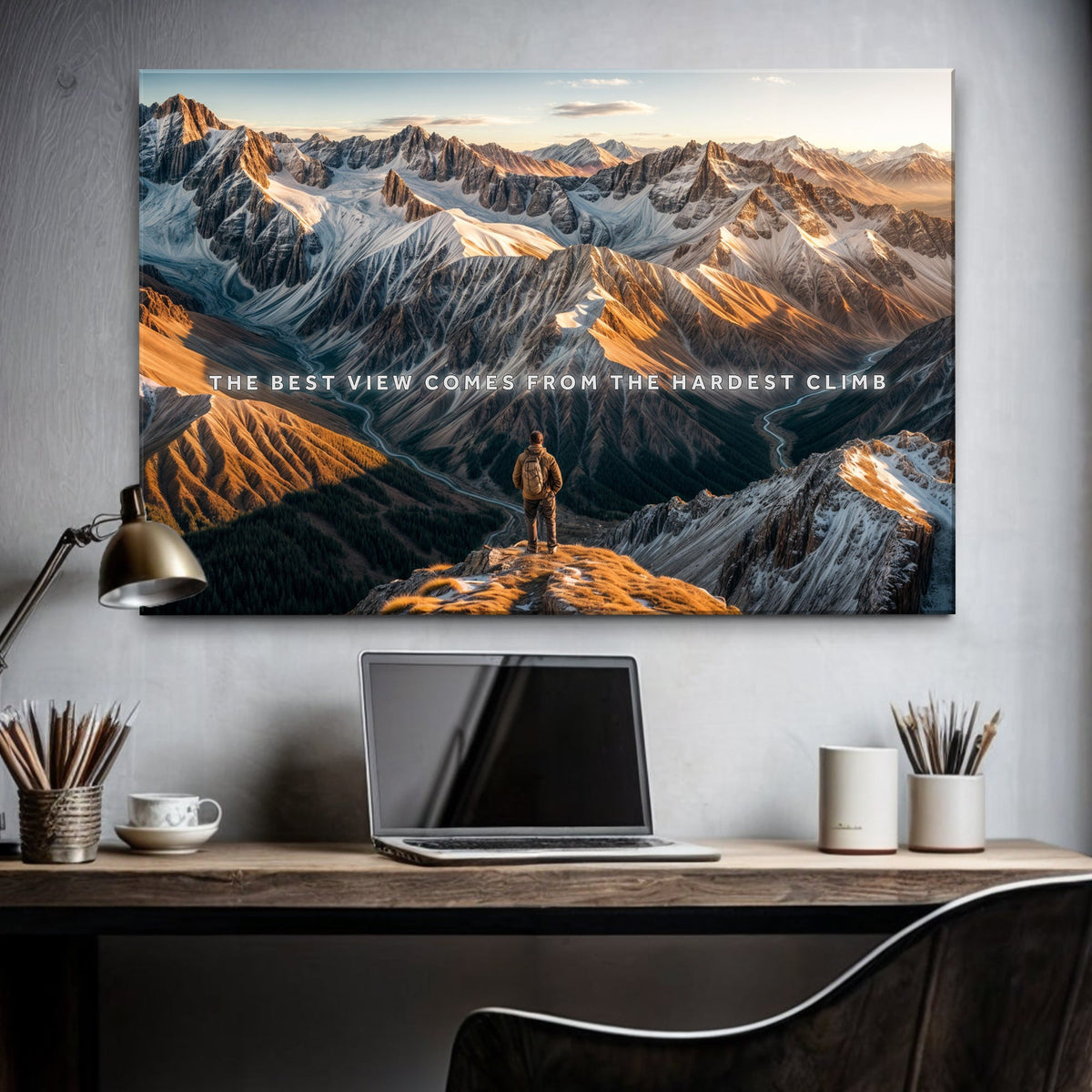 Mountainscape wall art with a person on a mountain peak in a home office setting.