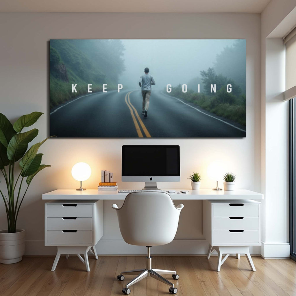Modern home office with motivational 'Keep Going' poster above a desk.
