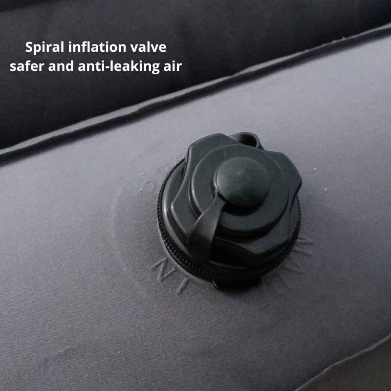Spiral inflation valve on an inflatable boat with text indicating safety features.