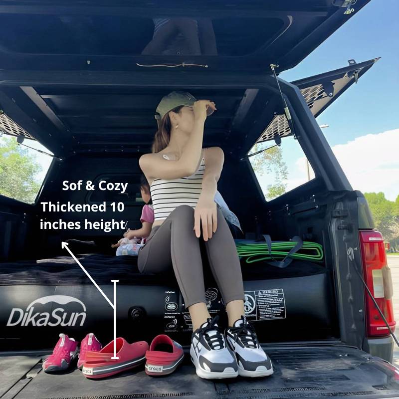 Person sitting in an open car trunk with DikaSun branded product and shoes.