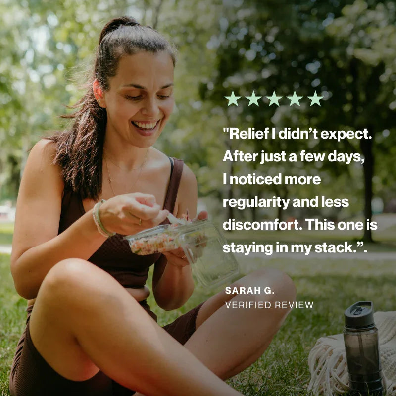 A woman sitting outdoors on grass in a park, eating from a clear plastic container. White text on the right reads a five-star review quote from Sarah G.