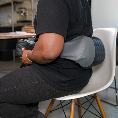 Person using a massage pillow in a kitchen setting