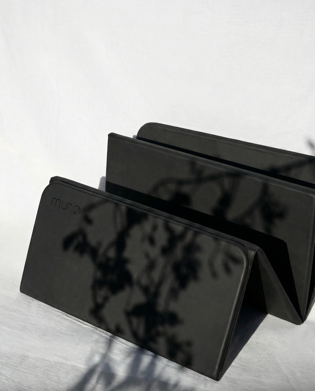 Black phone case with 'mous' branding on a light gray surface