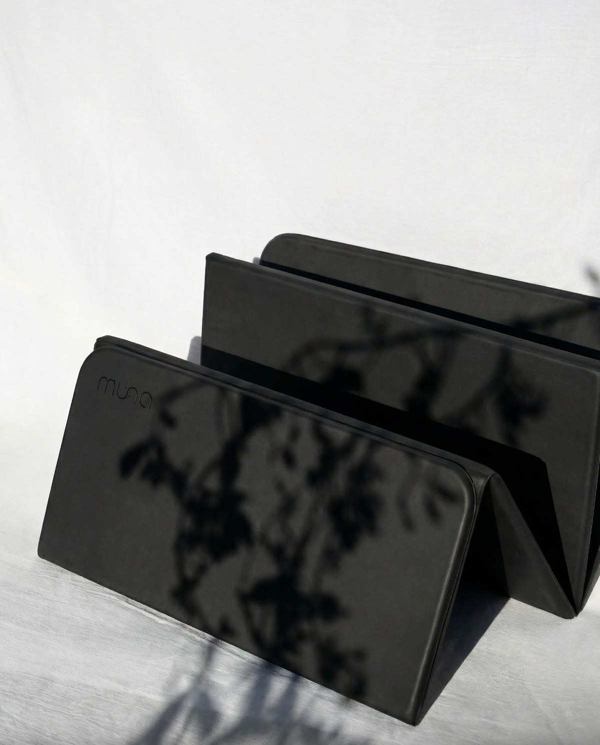 Black phone case with 'mous' branding on a light gray surface