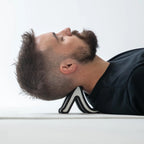 Person using a black and white shoe as a pillow on a white surface
