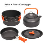 Set of camping cookware including a kettle, pan, and cooking pot with orange handles on a white background.