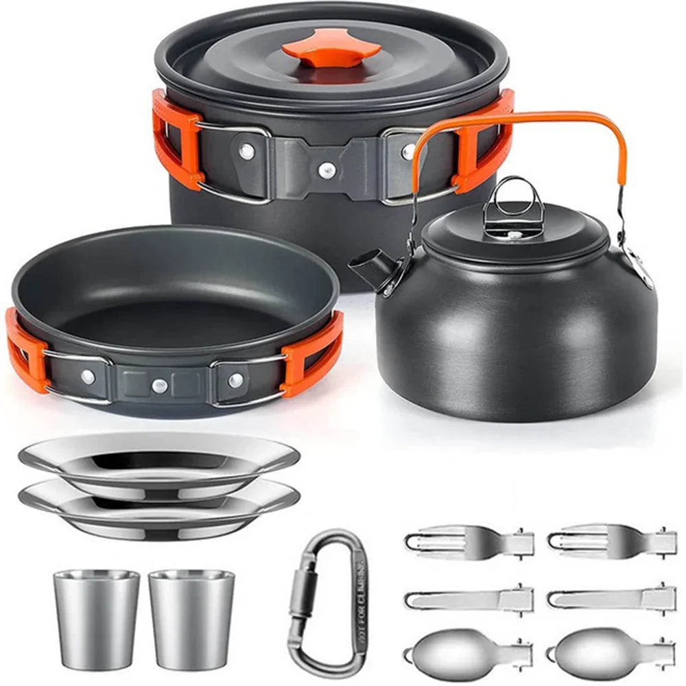 Camping cookware set with pots, pans, kettle, and utensils on a white background