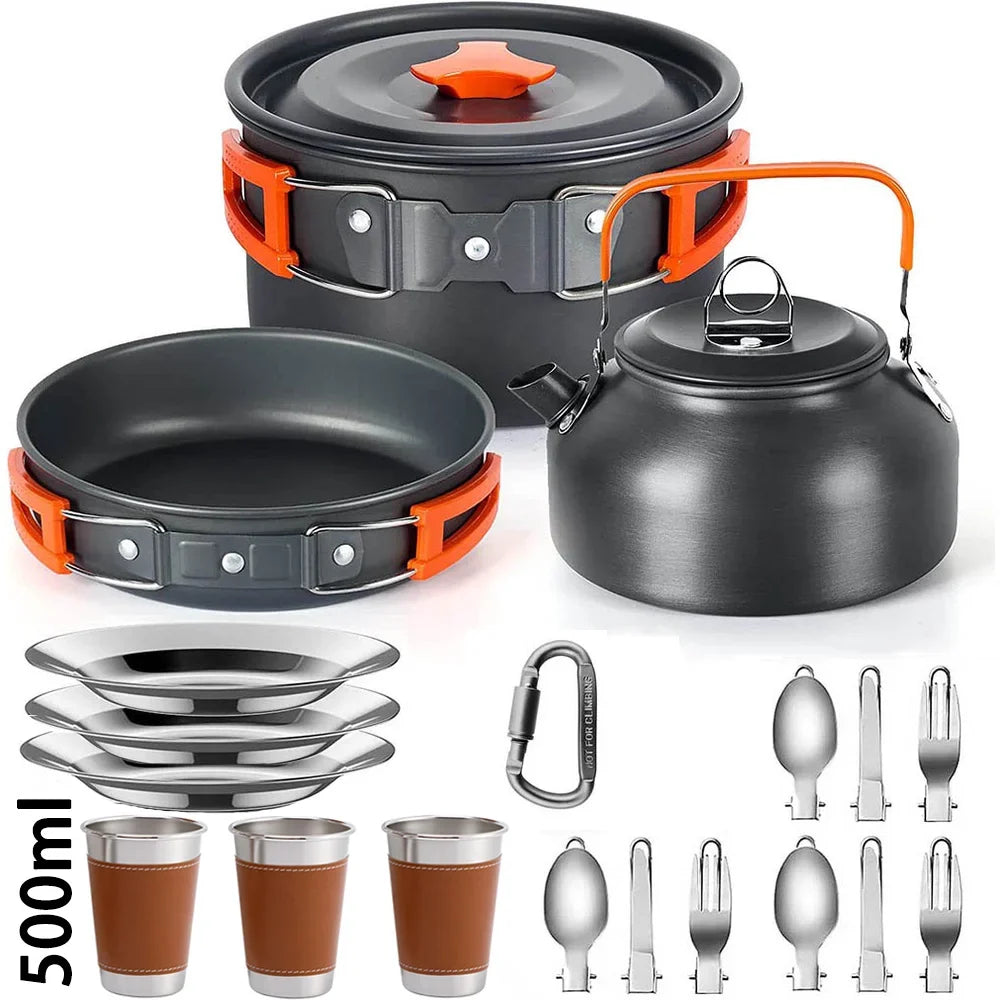 A camping cookware set on a white background, including a black pot with lid, a black frying pan, a black kettle with orange handle, four stainless steel plates, four brown-and-silver tumblers, a carabiner, and multiple utensils.