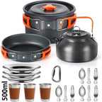 A camping cookware set on a white background, including a black pot with lid, a black frying pan, a black kettle with orange handle, four stainless steel plates, four brown-and-silver tumblers, a carabiner, and multiple utensils.