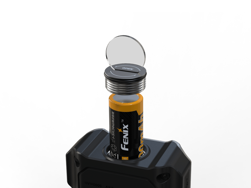 A cylindrical battery with a black and yellow Fenix label is shown inserted into a black device, with a clear circular cover or lens propped open above the battery on a white background.