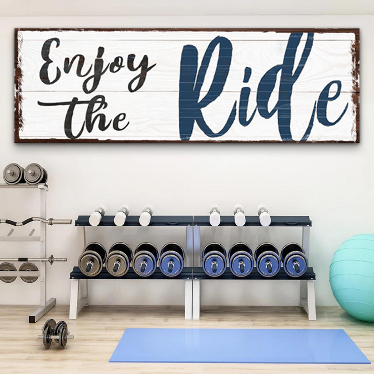 Gym interior with weight rack and motivational sign 'Enjoy the Ride'.