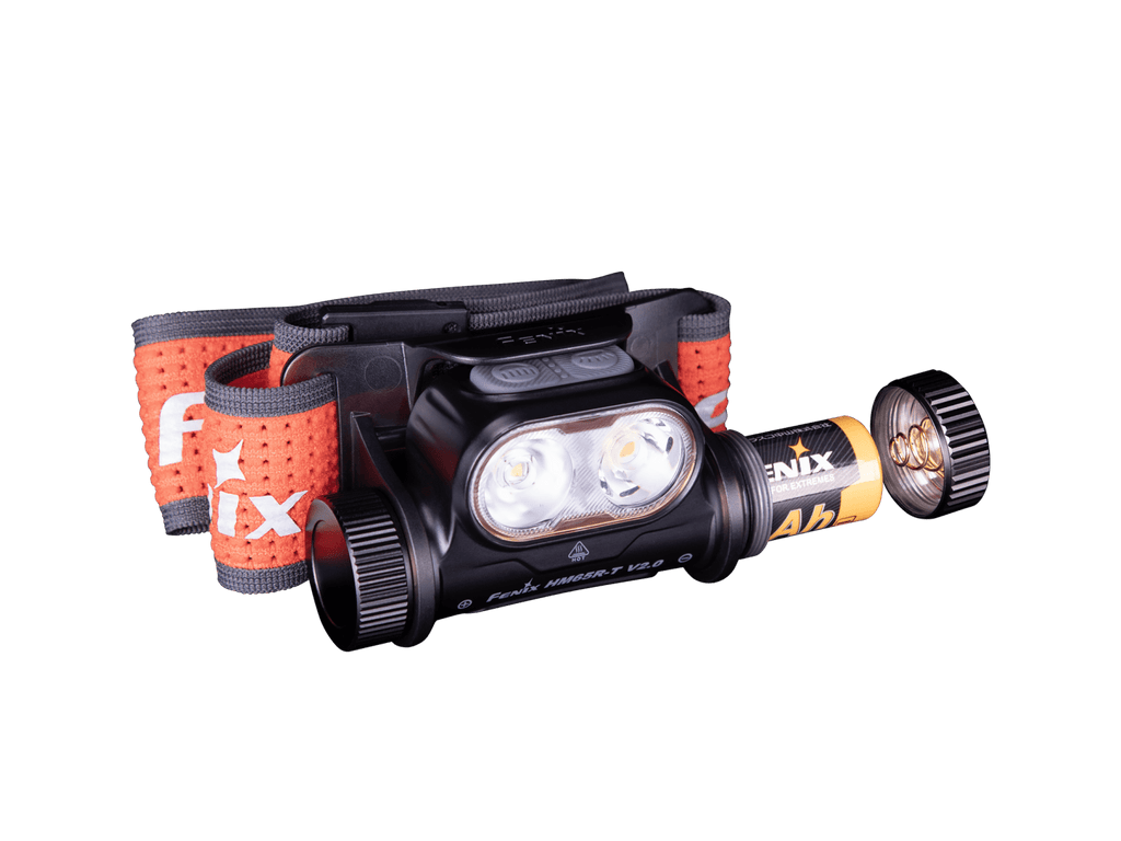 Headlamp with orange strap on a green background