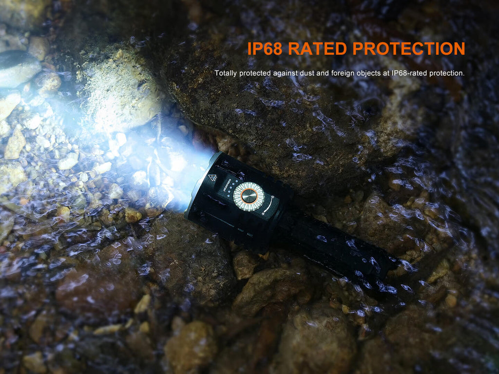 Flashlight underwater with IP68 rating text on a rocky surface